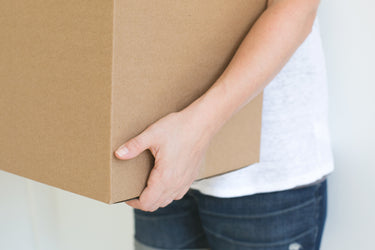 Person Holding Cardboard Box